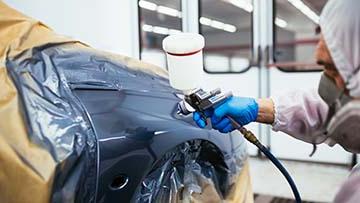 Car being spray painted.